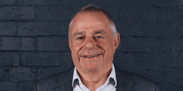 headshot of peter lamell on grey background