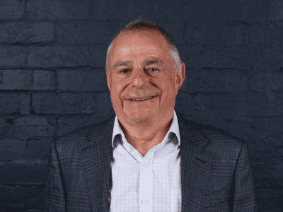 headshot of peter lamell on grey background